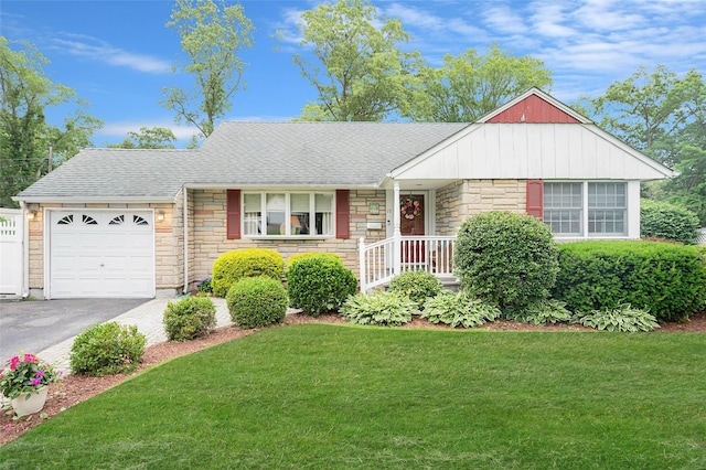 15 Peony Ln, Commack, NY 11725 - view of front of home with stone siding, a shingled roof, a garage, a front yard, and asphalt driveway