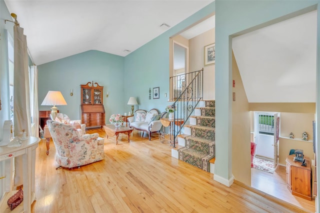 15 Peony Ln, Commack, NY 11725 - living room featuring vaulted ceiling, wood finished floors, and stairs