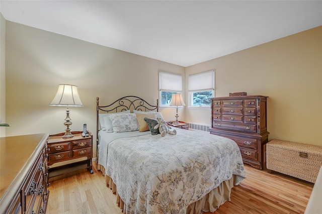15 Peony Ln, Commack, NY 11725 - bedroom with light wood-type flooring and radiator heating unit