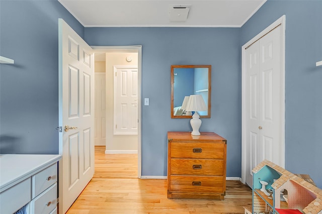 15 Peony Ln, Commack, NY 11725 - bedroom with light wood finished floors, a closet, and crown molding