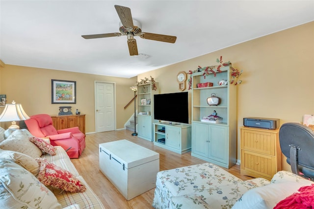 15 Peony Ln, Commack, NY 11725 - living room with light wood-style floors, a ceiling fan, and stairway