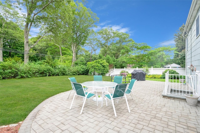 15 Peony Ln, Commack, NY 11725 - fenced backyard with a patio area, grilling area, outdoor dining space, and view of scattered trees