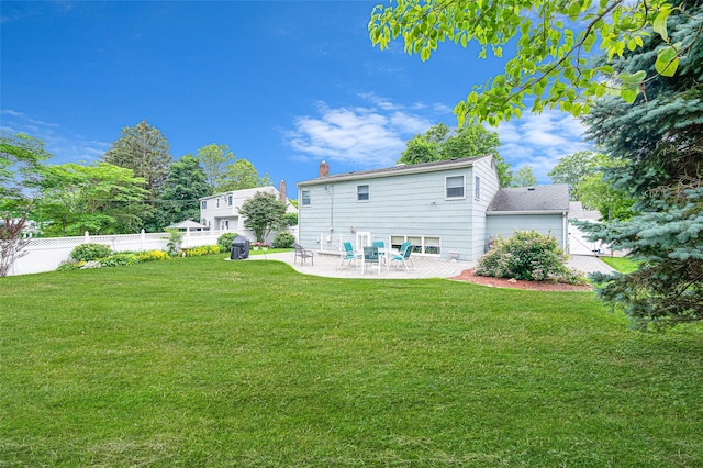 15 Peony Ln, Commack, NY 11725 - rear view of house with a patio area and a chimney
