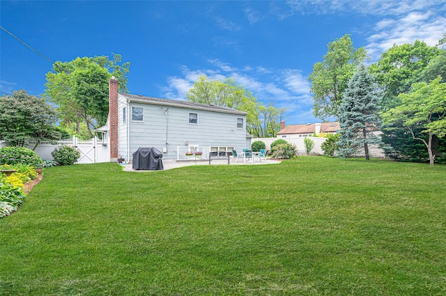 15 Peony Ln, Commack, NY 11725 - back of property with a patio area, a fenced backyard, and a chimney