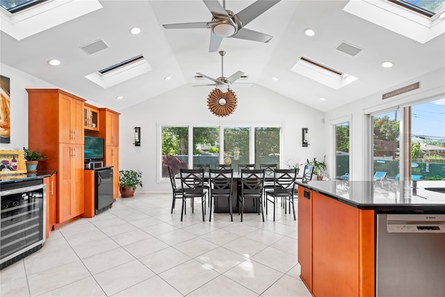 128 Seaman Rd, Jericho, NY 11753 - kitchen with a skylight, wine cooler, stainless steel dishwasher, brown cabinets, and vaulted ceiling