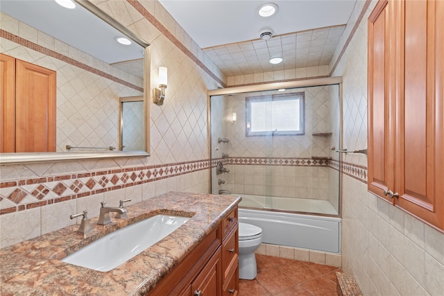 128 Seaman Rd, Jericho, NY 11753 - full bath with tile walls, tile patterned floors, vanity, bath / shower combo with glass door, and recessed lighting