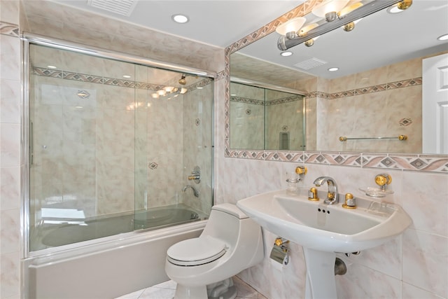 128 Seaman Rd, Jericho, NY 11753 - bathroom featuring tile walls, combined bath / shower with glass door, recessed lighting, and tile patterned flooring