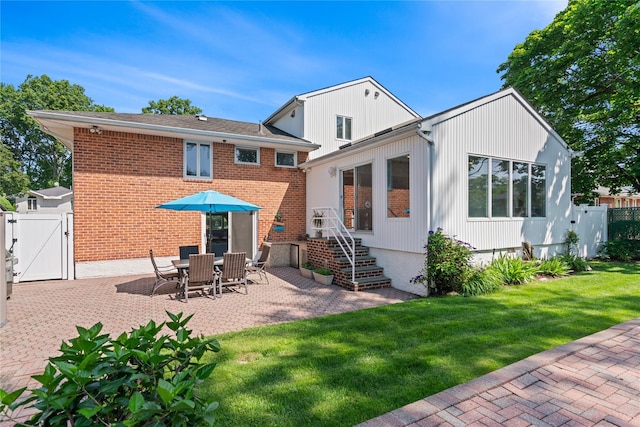 128 Seaman Rd, Jericho, NY 11753 - back of house with a gate, a patio area, and brick siding