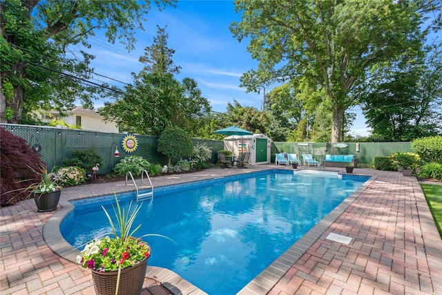 128 Seaman Rd, Jericho, NY 11753 - view of pool with a fenced backyard, a patio area, and a storage unit