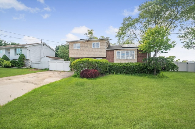 38 W 17th St, Deer Park, NY 11729 - tri-level home with a gate, driveway, and roof mounted solar panels