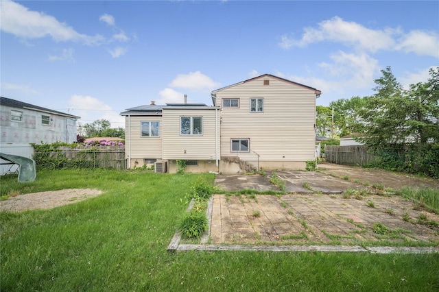 38 W 17th St, Deer Park, NY 11729 - back of property featuring roof mounted solar panels and a patio