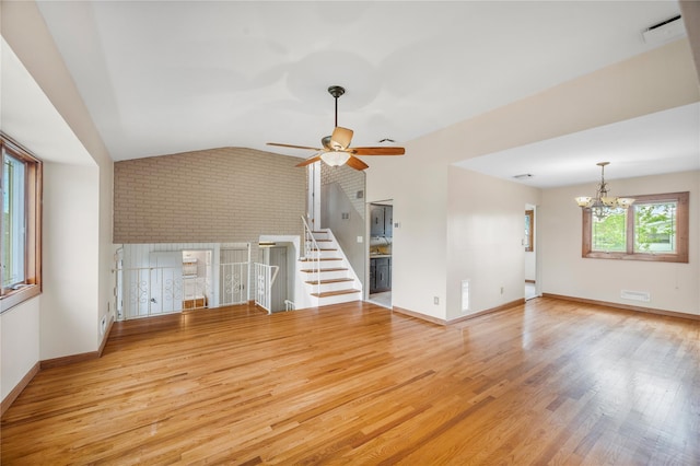 38 W 17th St, Deer Park, NY 11729 - unfurnished living room featuring lofted ceiling, wood finished floors, a chandelier, and a ceiling fan