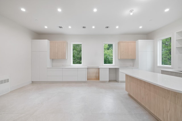 15 Gilda Ct, Spring Valley, NY 10977 - kitchen featuring modern cabinets, light brown cabinets, light countertops, healthy amount of natural light, and recessed lighting