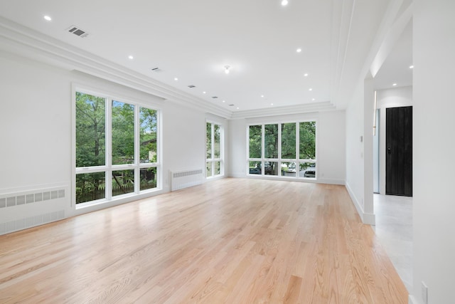 15 Gilda Ct, Spring Valley, NY 10977 - unfurnished living room featuring radiator, ornamental molding, light wood-style floors, and recessed lighting