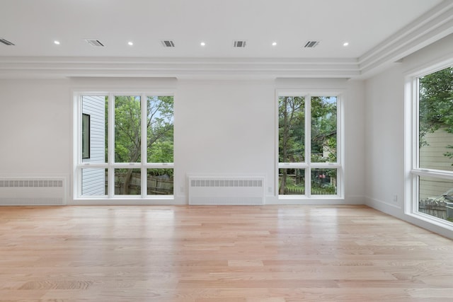 15 Gilda Ct, Spring Valley, NY 10977 - unfurnished living room featuring radiator, light wood-style floors, and recessed lighting