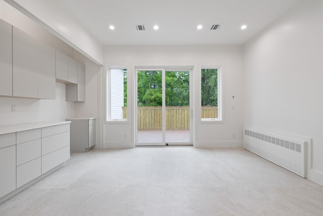 15 Gilda Ct, Spring Valley, NY 10977 - unfurnished dining area featuring radiator heating unit and recessed lighting