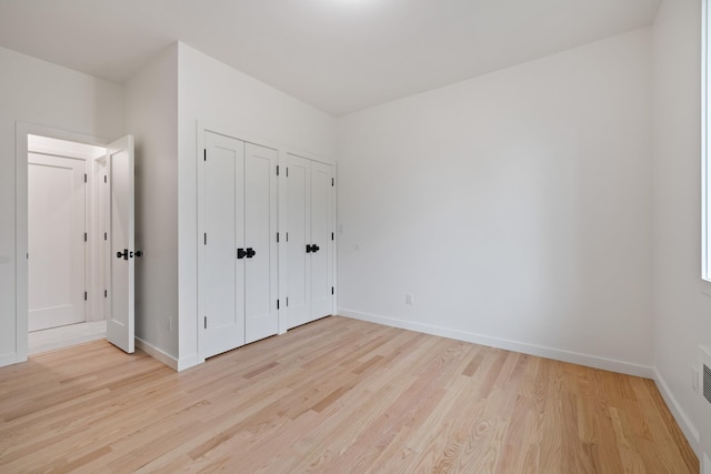 15 Gilda Ct, Spring Valley, NY 10977 - unfurnished bedroom featuring multiple closets and light wood-style floors