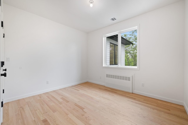 15 Gilda Ct, Spring Valley, NY 10977 - unfurnished room featuring radiator heating unit and light wood finished floors