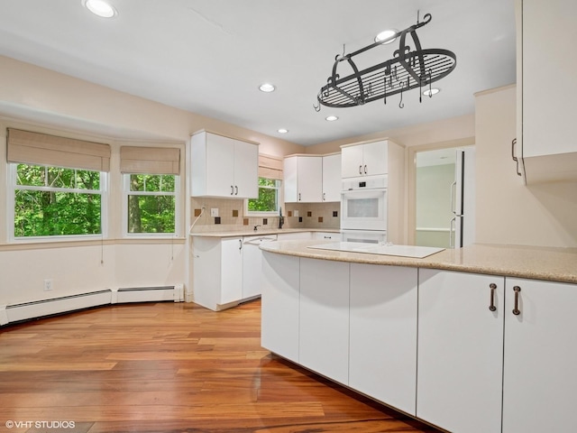 10 Silvermine Dr, South Salem, NY 10590 - kitchen featuring a peninsula, white cabinets, white appliances, recessed lighting, and light wood-type flooring