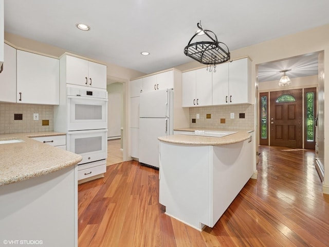 10 Silvermine Dr, South Salem, NY 10590 - kitchen with white appliances, backsplash, light wood-style flooring, white cabinetry, and recessed lighting