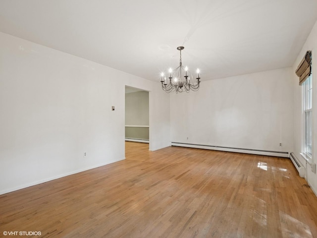 10 Silvermine Dr, South Salem, NY 10590 - spare room featuring a chandelier, light wood-style flooring, and baseboard heating