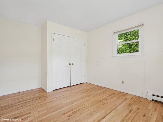 10 Silvermine Dr, South Salem, NY 10590 - unfurnished bedroom featuring light wood finished floors, a closet, and a baseboard radiator