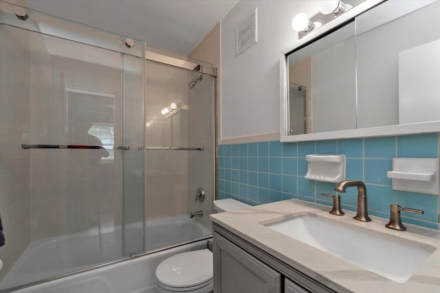 69-28 43rd Ave, Woodside, NY 11377 - full bathroom with tile walls, shower / bath combination with glass door, and vanity