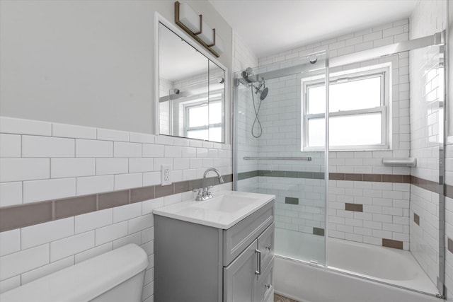 69-28 43rd Ave, Woodside, NY 11377 - bathroom with vanity, tile walls, and bath / shower combo with glass door