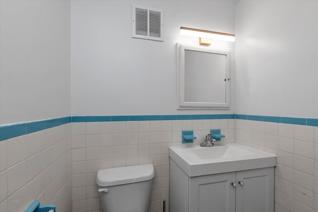 69-28 43rd Ave, Woodside, NY 11377 - half bathroom featuring tile walls, vanity, and wainscoting