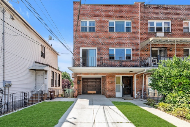 69-28 43rd Ave, Woodside, NY 11377 - multi unit property featuring brick siding, driveway, an attached garage, and a balcony