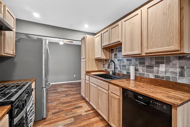 160 New Holland Vlg, Nanuet, NY 10954 - kitchen with black appliances, butcher block countertops, light brown cabinets, wood finished floors, and decorative backsplash
