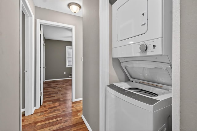 160 New Holland Vlg, Nanuet, NY 10954 - laundry area with stacked washing machine and dryer and wood finished floors