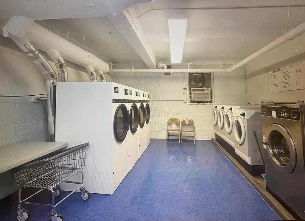 138-25 31st Dr Unit 3E, Flushing, NY 11354 - community laundry room with washing machine and dryer and concrete block wall
