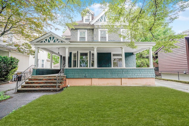 335 E 18th St, Brooklyn, NY 11226 - view of front of home featuring covered porch and a front lawn
