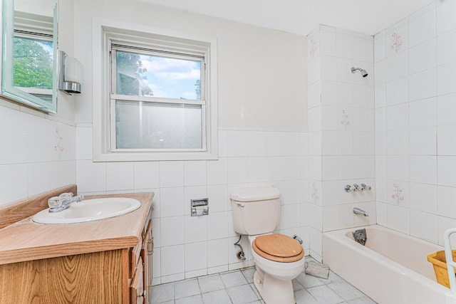 335 E 18th St, Brooklyn, NY 11226 - full bathroom featuring vanity, tile patterned flooring, tub / shower combination, tile walls, and a wainscoted wall