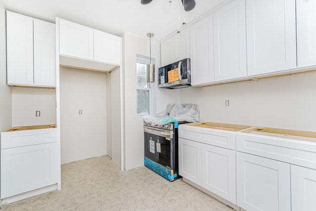 335 E 18th St, Brooklyn, NY 11226 - kitchen with appliances with stainless steel finishes, white cabinetry, light colored carpet, a ceiling fan, and light countertops