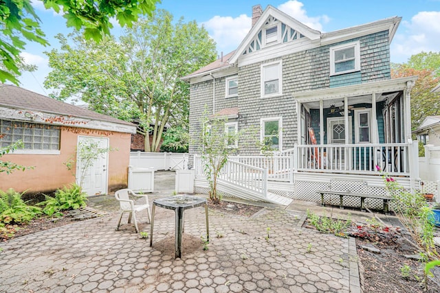 335 E 18th St, Brooklyn, NY 11226 - rear view of property featuring a patio, a chimney, a sunroom, a deck, and ceiling fan