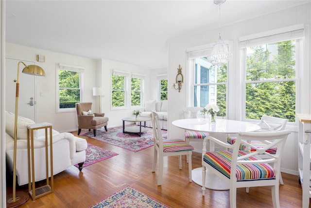 43 Washington Ave, Greenport, NY 11944 - dining area with plenty of natural light, wood finished floors, and a chandelier