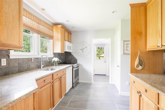 43 Washington Ave, Greenport, NY 11944 - kitchen featuring white appliances, plenty of natural light, tasteful backsplash, light stone counters, and recessed lighting