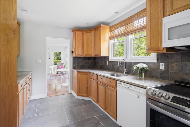 43 Washington Ave, Greenport, NY 11944 - kitchen with white appliances, backsplash, tile patterned flooring, and light stone countertops