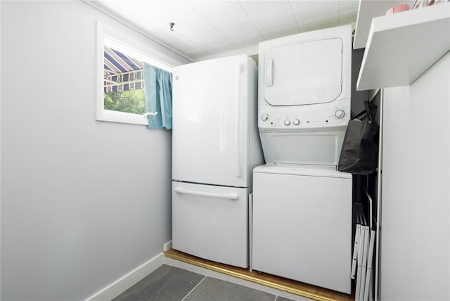 43 Washington Ave, Greenport, NY 11944 - washroom featuring stacked washer / dryer and tile patterned floors