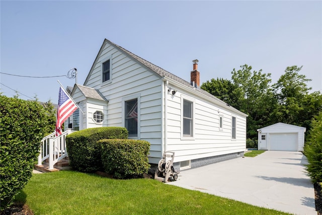 43 Washington Ave, Greenport, NY 11944 - view of front facade with an outdoor structure, a chimney, a front lawn, and a garage