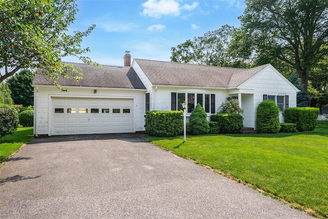 3000 Pequash Ave, Cutchogue, NY 11935 - ranch-style house featuring asphalt driveway, a chimney, a front yard, a garage, and a shingled roof