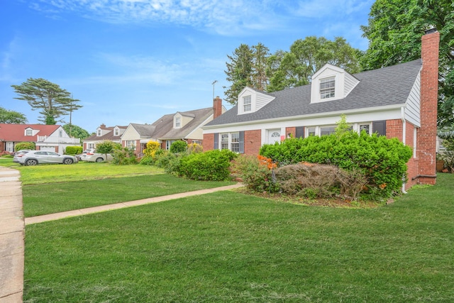 139 Jean Ave, Hempstead, NY 11550 - new england style home featuring brick siding, a front yard, a chimney, roof with shingles, and a residential view