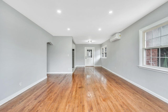 139 Jean Ave, Hempstead, NY 11550 - spare room with a wall mounted air conditioner, light wood finished floors, and recessed lighting