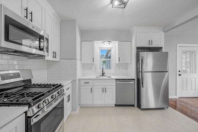 139 Jean Ave, Hempstead, NY 11550 - kitchen with appliances with stainless steel finishes, light countertops, and white cabinetry