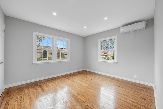 139 Jean Ave, Hempstead, NY 11550 - unfurnished room with a wall mounted AC, light wood-style flooring, and recessed lighting