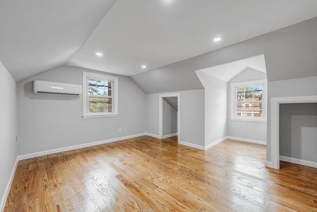 139 Jean Ave, Hempstead, NY 11550 - bonus room with a wall mounted AC, healthy amount of natural light, vaulted ceiling, light wood-style flooring, and recessed lighting