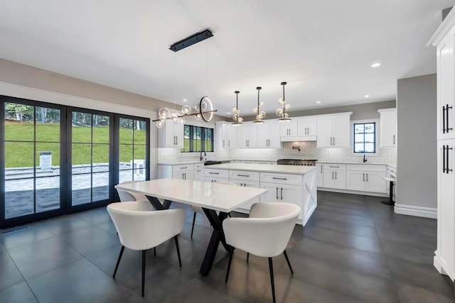 589 Old Bridge Rd, Northport, NY 11768 - dining space featuring plenty of natural light, a chandelier, recessed lighting, and dark tile patterned floors