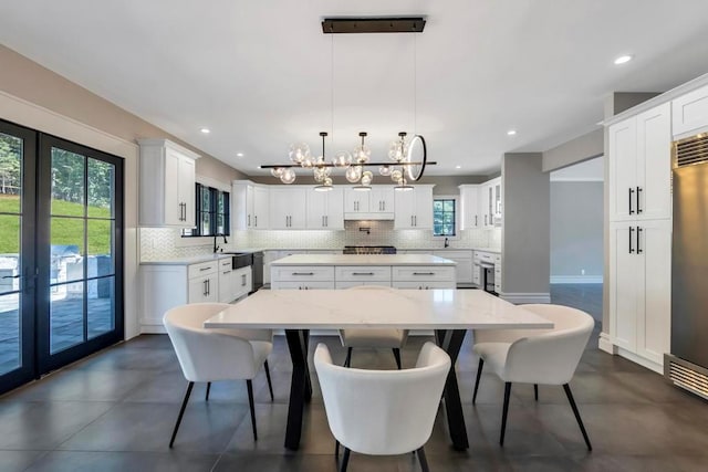 589 Old Bridge Rd, Northport, NY 11768 - dining room with a chandelier, recessed lighting, french doors, and concrete floors